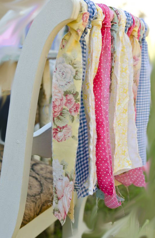 Chair decorated by older siblings with colored ribbons and flower fabric